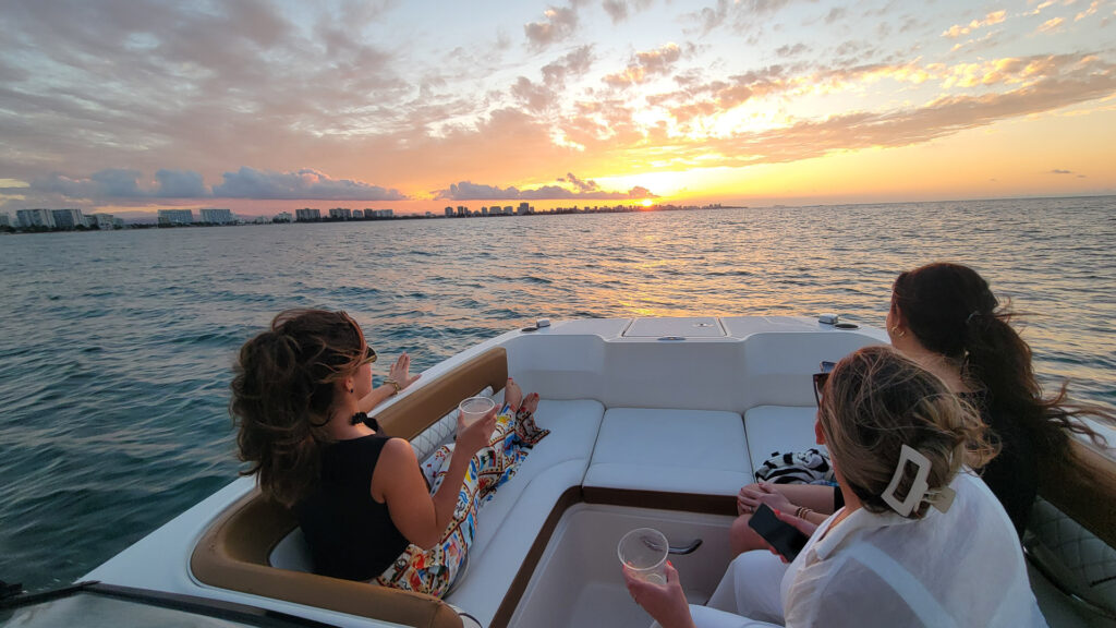 Friends watching the sunset from a boat near San Juan, Puerto Rico
